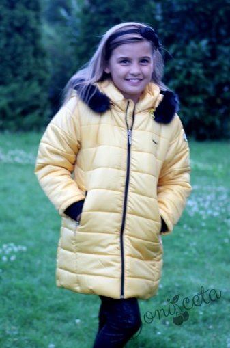 Winter  jacket in mustard colour with a hood 