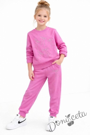 Спортен комплект за момиче от горнище и долнище в розово с панделки