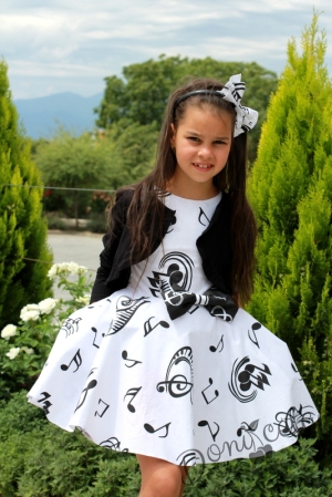Официална детска рокля в бяло тип клош с ноти с болеро в черно  Симона