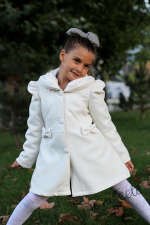 Children's winter coat for a girl in white with lace and ribbons