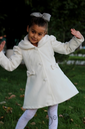Children's winter coat for a girl in ecru with lace and ribbons