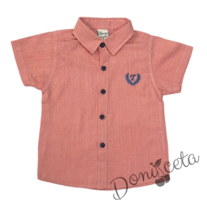 Set of children's short sleeve shirt with emblem in peach and short jeans in blue.